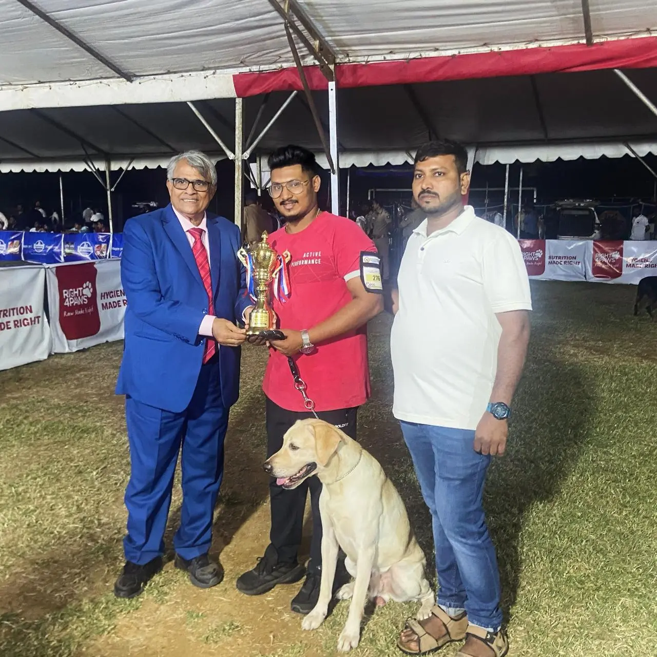 Praveen Shankar receiving recognition at a canine event